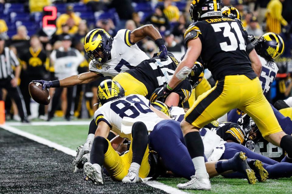 Michigan running back Donovan Edwards scores a touchdown against Iowa during the second half of the 42-3 win over Iowa in the Big Ten championship game on Saturday, Dec. 4, 2021, in Indianapolis.