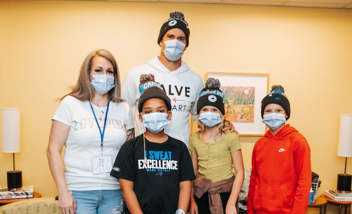 Greg Olsen distributes beanies at Atrium Health Levine Children's Hospital