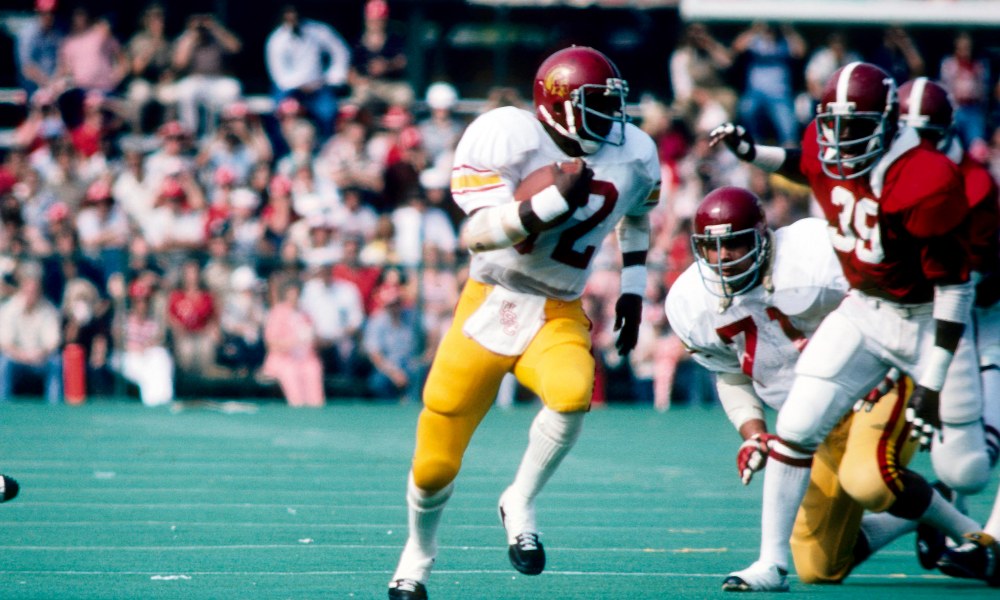 Charles White smiled when anyone gave him the USC Fight On symbol