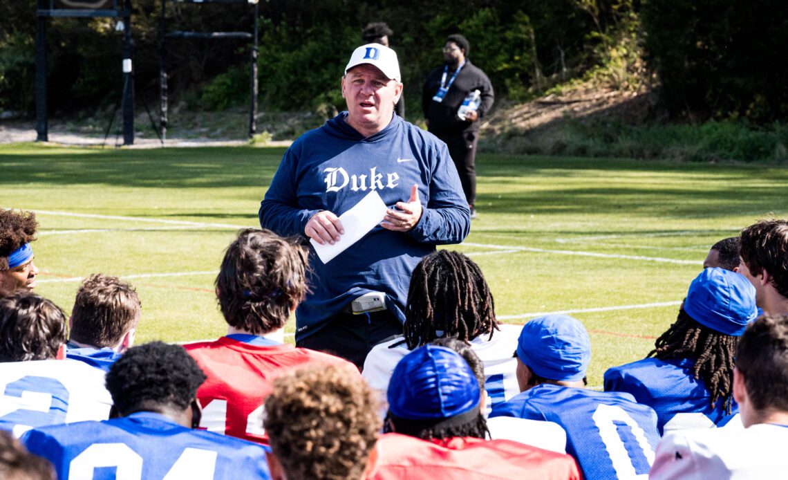 Duke football head coach Mike Elko speaks with his team after the Blue Devils' first spring practice